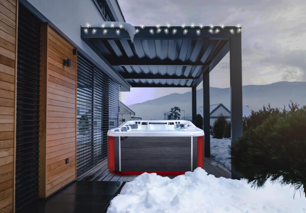 hot tub in a backyard under a patio cover in the winter season with snow on the ground