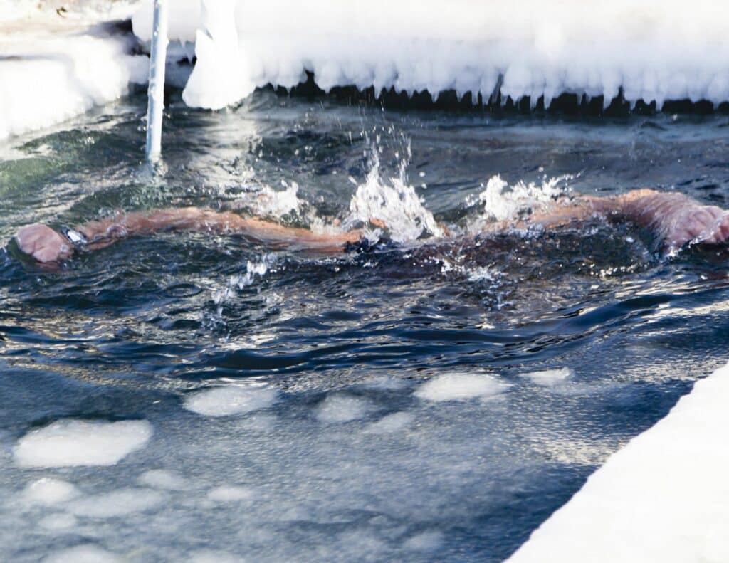 athlete swims in ice water